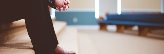 Man sitting on steps in church