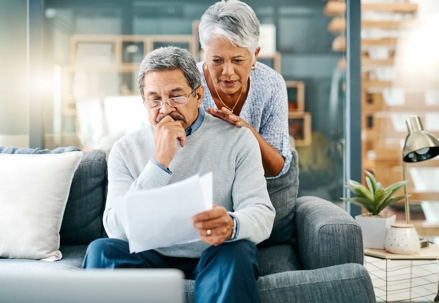 an elder couple looking at paperwork