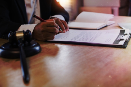 person in a lawyer's office signing a document