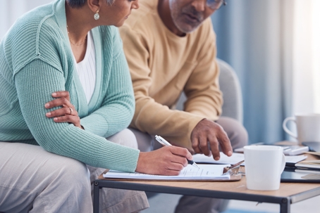 elderly couple looking over documents
