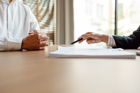 person discussing documents with a lawyer