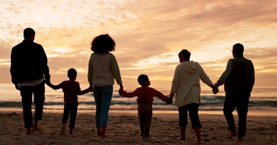 family at the beach during sunset