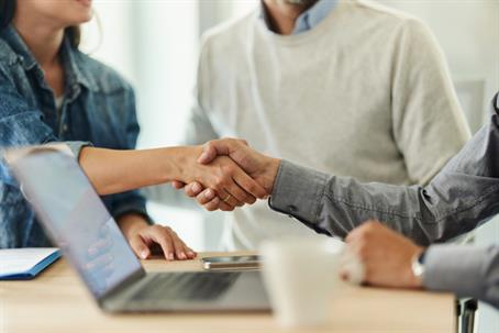 couple shaking hands with advisor
