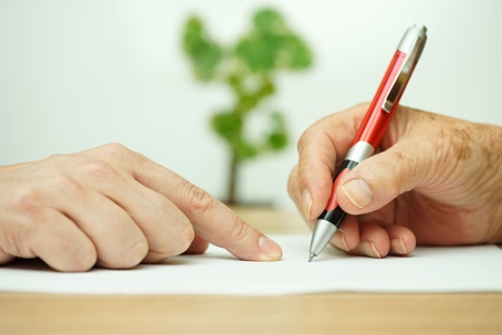 One hand directing and elderly hand to sign